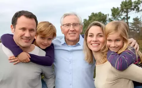 Family portrait looking to camera smiling together