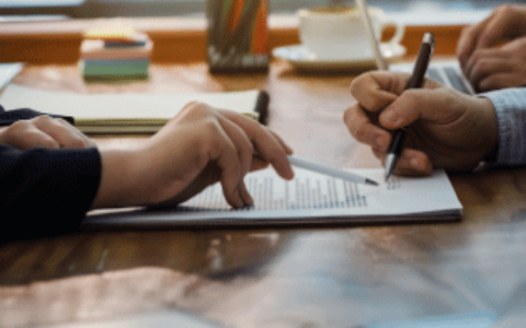 Individuals reviewing documentation on desk