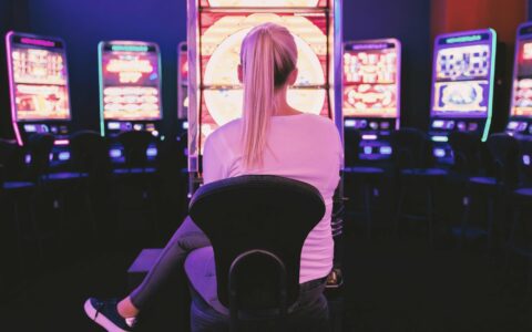 woman sat infront of gambling machines
