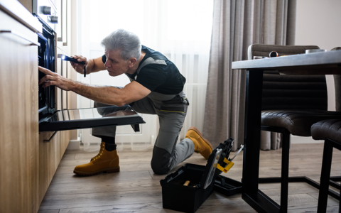 Man fixing the oven