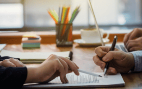 Individuals reviewing documentation on desk