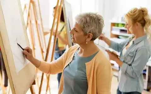 Person Drawing On Easel At Art School Studio