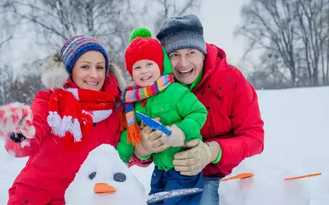 family building a snowman