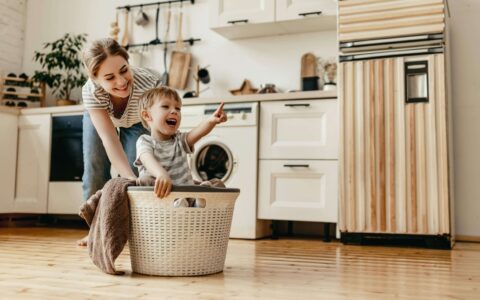 Child and lady in kitchen. Child pointing.