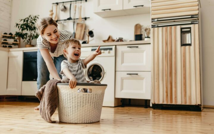 Child and lady in kitchen. Child pointing.