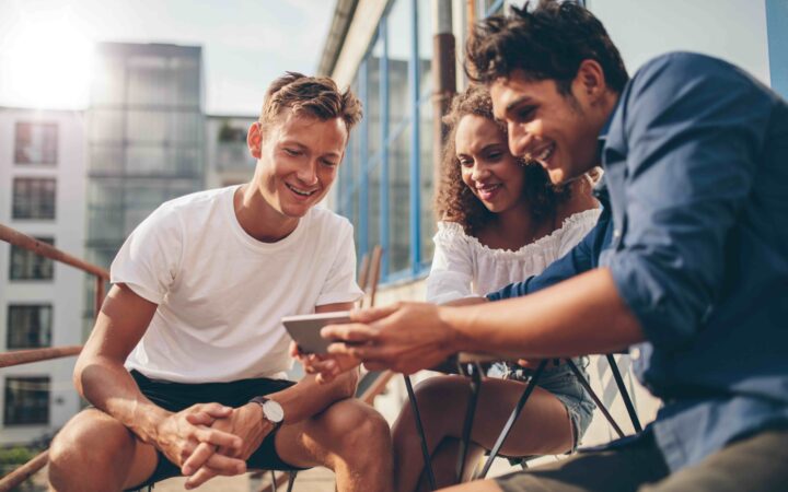 Group of people watching video on the mobile phone